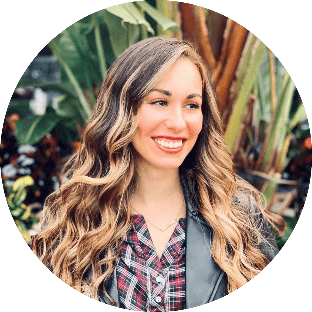 A woman with long hair is smiling for the camera.