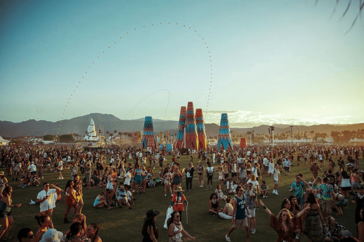 A crowd of people sitting on the grass.