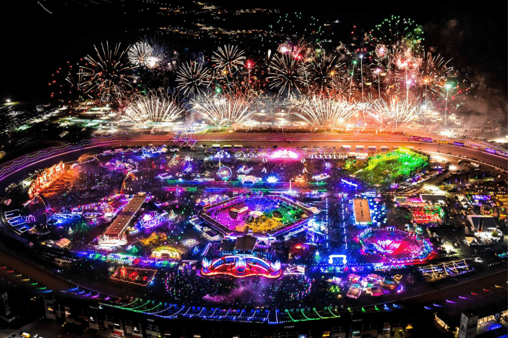 A large field with fireworks in the background.