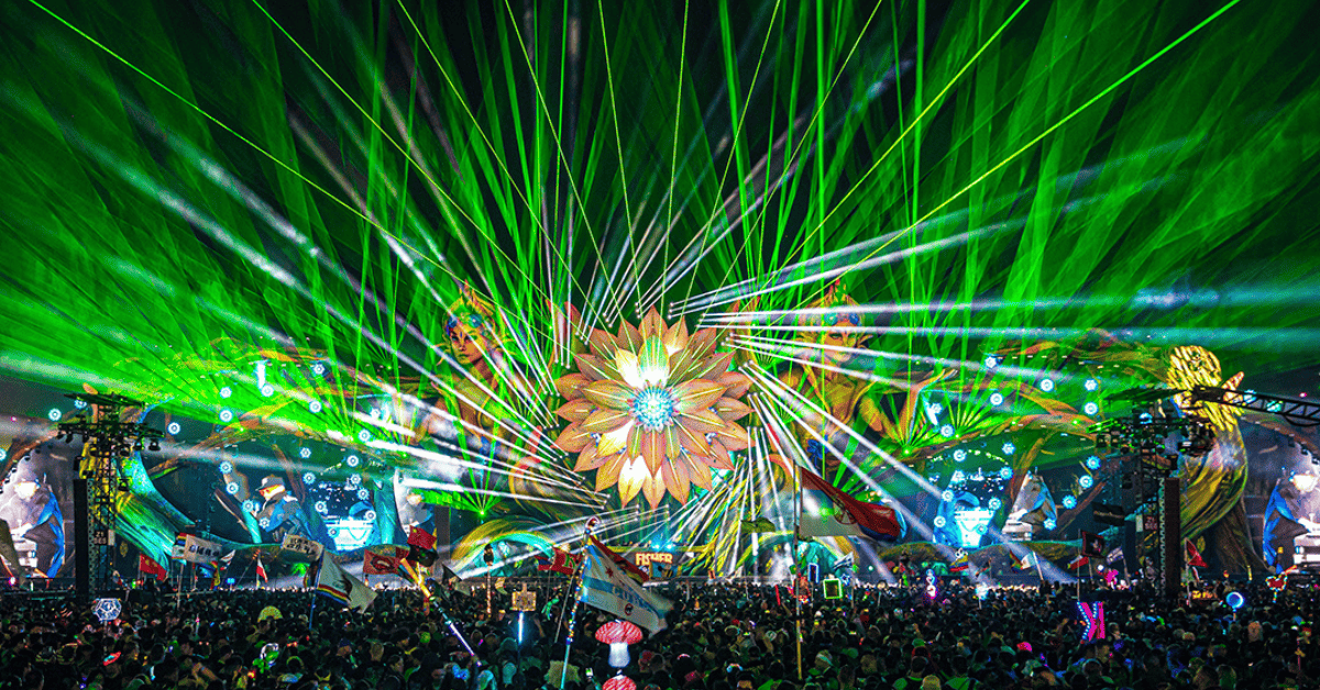 A large green field with lights and people